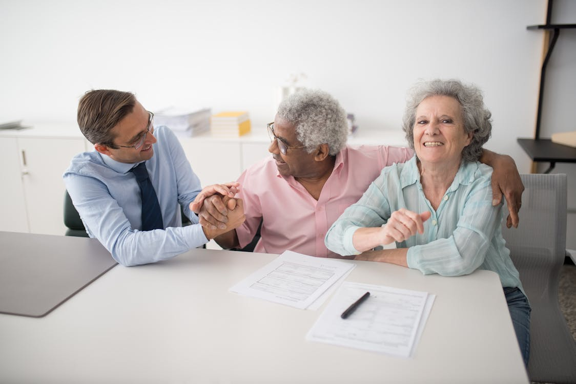 A happy senior couple with a public adjuster