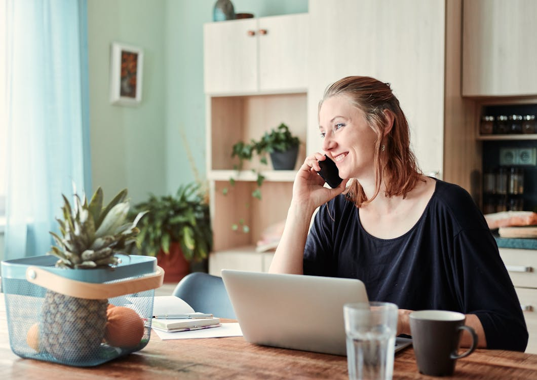 Smiling person talking on the phone